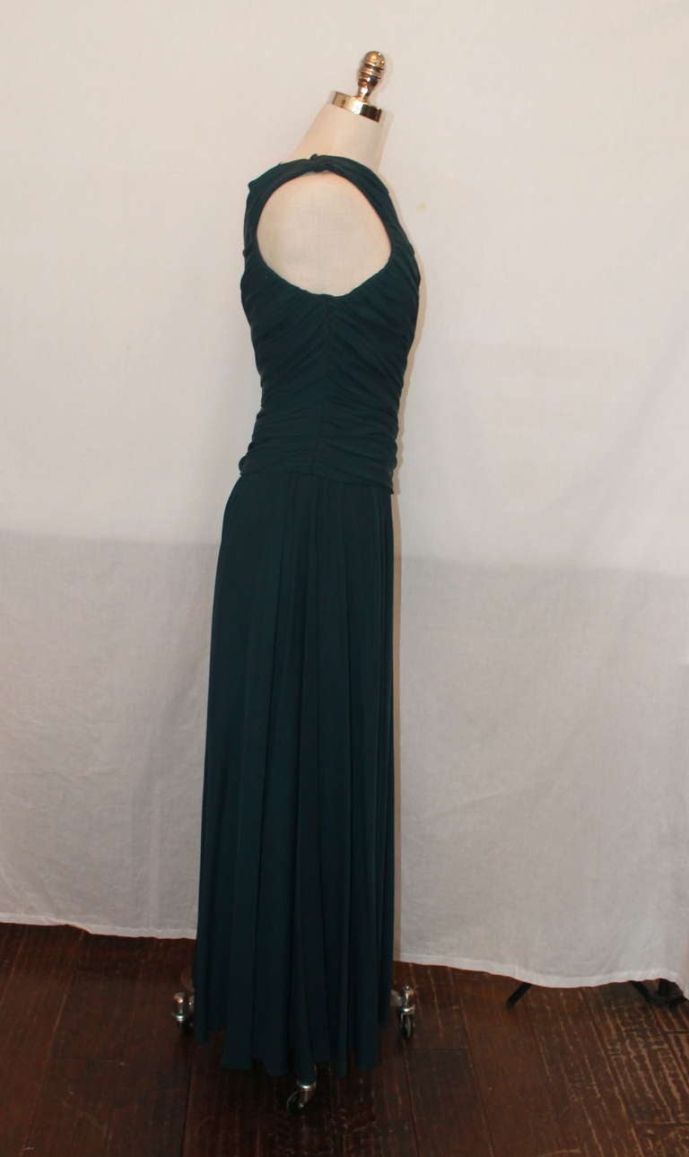 Carolyn Roehm dark teal matte jersey gown. It has a crossed neck and a diagonally ruched bodice. The gown is in excellent condition and is a size 4.
Measurements:
Bust- 35