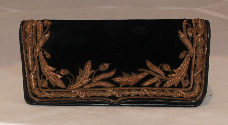 Ralph Lauren Collection black & bronze velvet clutch. Clutch has a bronze sewn applique of vines with sequin detail and a magnetic clasp. It is in impeccable condition and comes with a duster & case. 
Measurements:
Height- 4