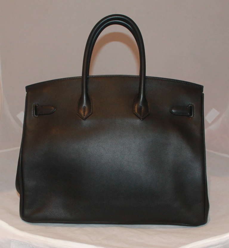 Hermes black veau swift leather 35 cm birkin. Bag is like new with box, 2 dusters, 2 rain pouches, and Hermes shopping bag. Circa 2009.
Measurements:
Width-13