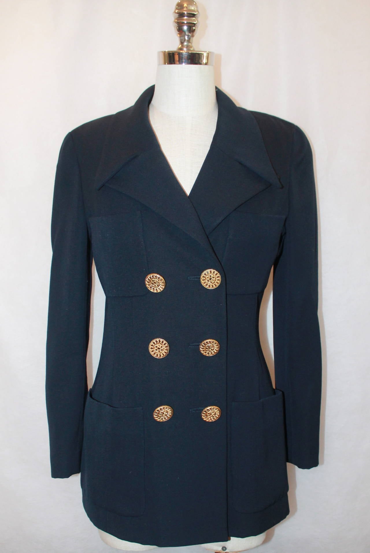 Chanel 1980's Vintage Navy Wool Blend 4-Pocket Jacket - M. This jacket is in very good vintage condition with light wear. It was 6 large buttons and 4 pockets on the front. 

Measurements:
Bust- 34"
Shoulder to Shoulder- 15"
Waist-