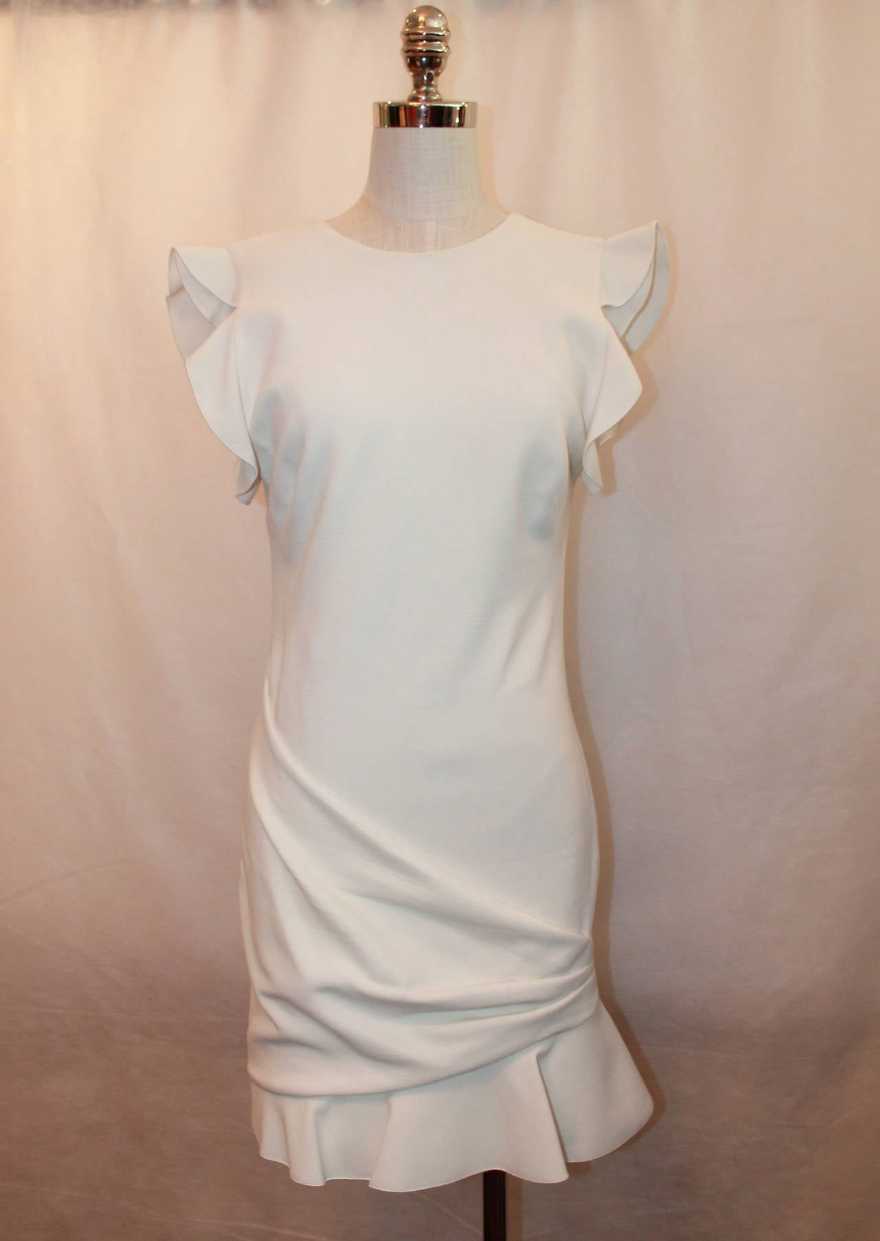 NEW Emilio Pucci Ivory Wool Blend Short Dress - 10. This dress is in excellent condition and has the original tag on it. The sleeves are a ruffle and the bottom has a gathering with large ruffle. 

Measurements:
Bust- 36