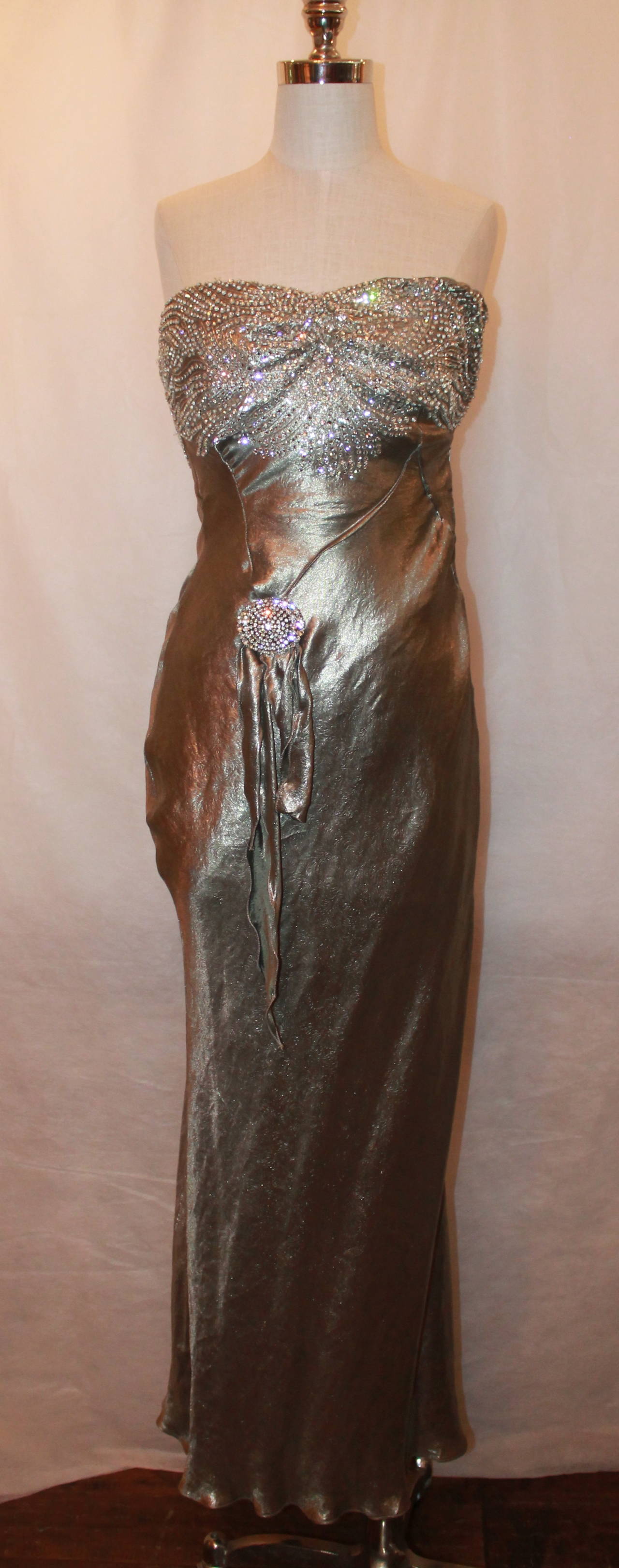 Ralph Lauren Couture Gunmetal Silk Lame Rhinestone Gown - XS. This gown is in excellent condition with very light wear. This strapless gown has a rhinestone & sequin design on the bust and also has a rhinestone pendant in the front.