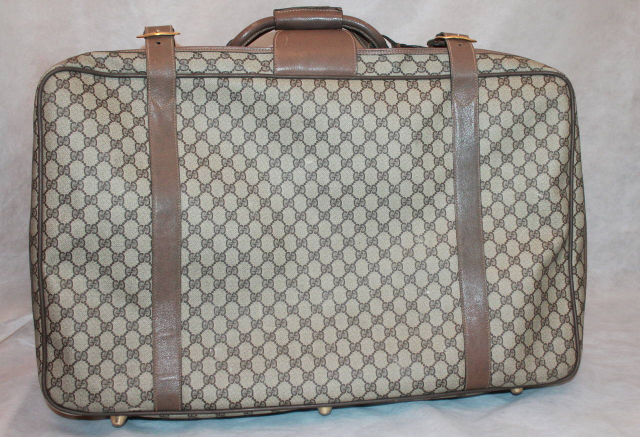 Gucci 1980's Vintage Printed Luggage Piece. This piece is in fair vintage condition with visible use. There are scuffs all along the leather trim with most of it on the sides. There is slight rust on the hardware as well. Since this piece is older,