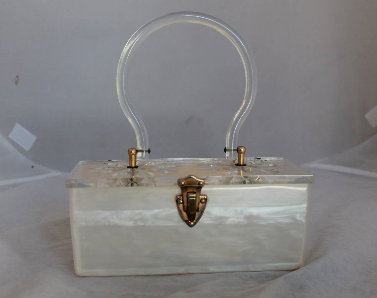 1950s Vintage Reverse Carved Lucite Frosted Top Handle Handbag. This bag is in fair vintage condition with wear consistent with being 65 years old. The top of the bag has a carved design on both sides with a Lucite top handle. The hardware shows