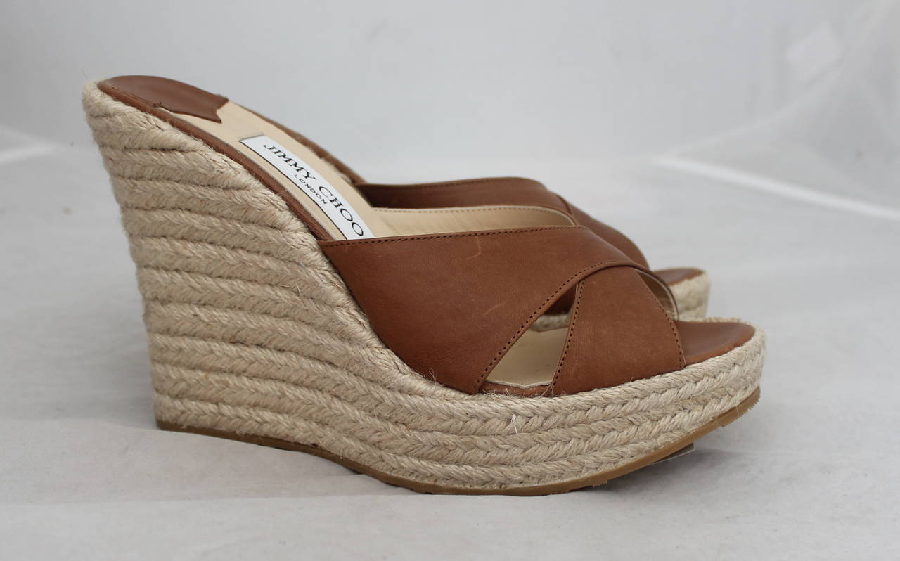 Jimmy Choo Brown Leather and Straw Wedge Slides. These Size 41 Shoes are in Excellent Condition with Very Slight Wear on the Leather.