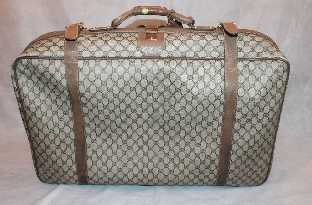 Gucci Vintage 1980's Printed Monogram Luggage Piece. This piece is in fair vintage condition with wear consistent to its age. There is scuffing all along the leather trim with a majority on the sides and bottom. The hardware shows some signs of use.