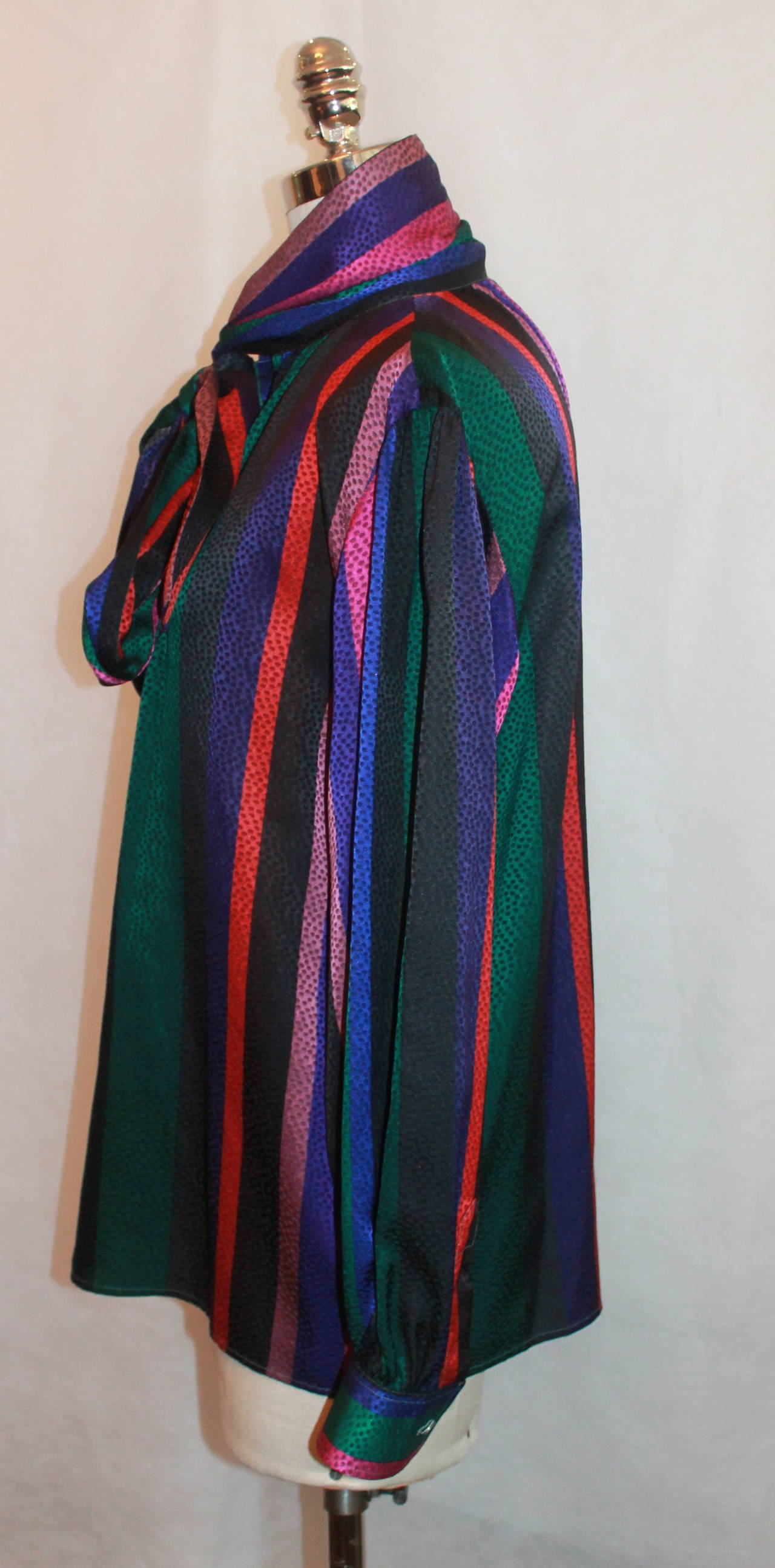 YSL 1960's Vintage Multi-Color Silk Blouse - L. This top is in excellent vintage condition with light wear. It is loose and has a neck tie. The print is striped with dots and has purples, pinks, blues, greens, and reds.

Measurements:
Bust- up to