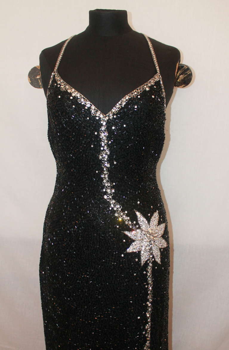 Unknown Black & Silver Vintage Beaded Gown. This gown is cross-back with a front slit and beaded flower motif. It is in excellent vintage condition with very minor snags. Size 6.
Measurements:
Bust- 33.5