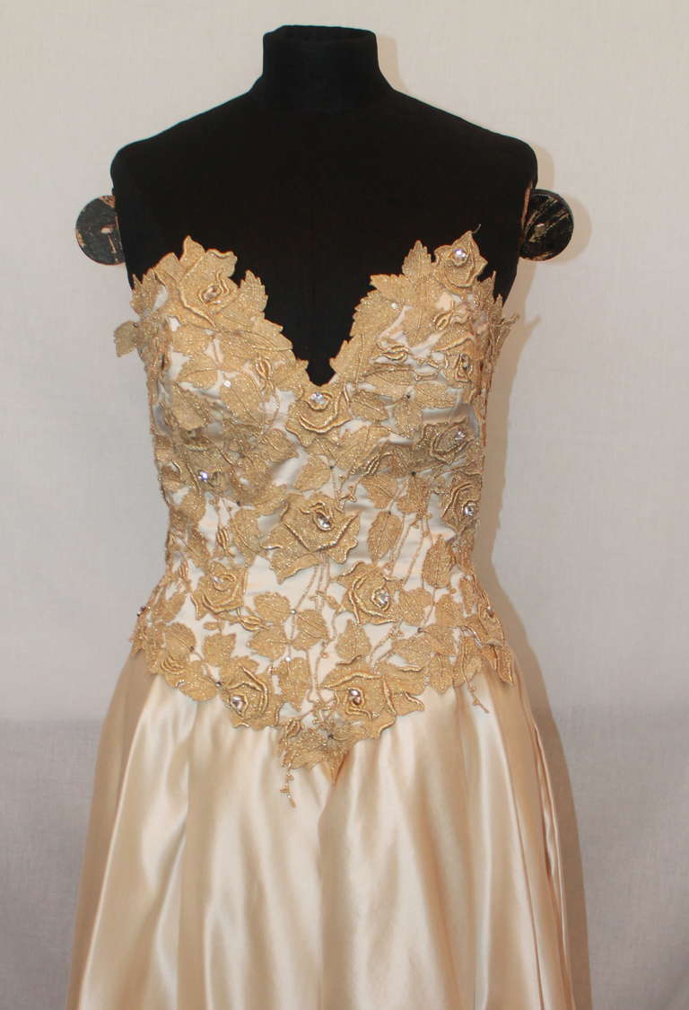 Yoly Munoz Vintage Ivory Satin Gown with Golden Vine Embroidery on Bodice. The bodice has pearl and rhinestone accents. The gown is in excellent condition. Size 8.
Measurements:
Bust- 35