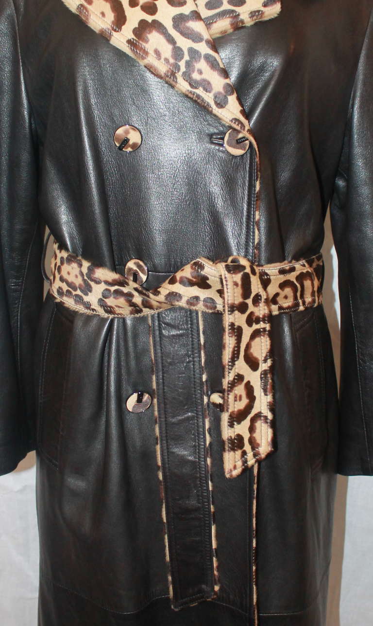 Fendi Chocolate Brown Leather & Leopard Skin Trench Coat. It has a leopard skin collar, belt, and buttons with a Fendi print lining. This trench was a custom piece and is in excellent condition. Size Medium. Circa 1990s.
Measurements:
Shoulder to