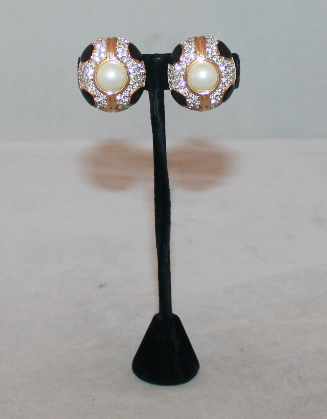 Ciner 1990's Vintage Black Enamel Pearl Clip-ons with Rhinestones. These earrings are in excellent condition and are gold-tone. 

Length- 1.25