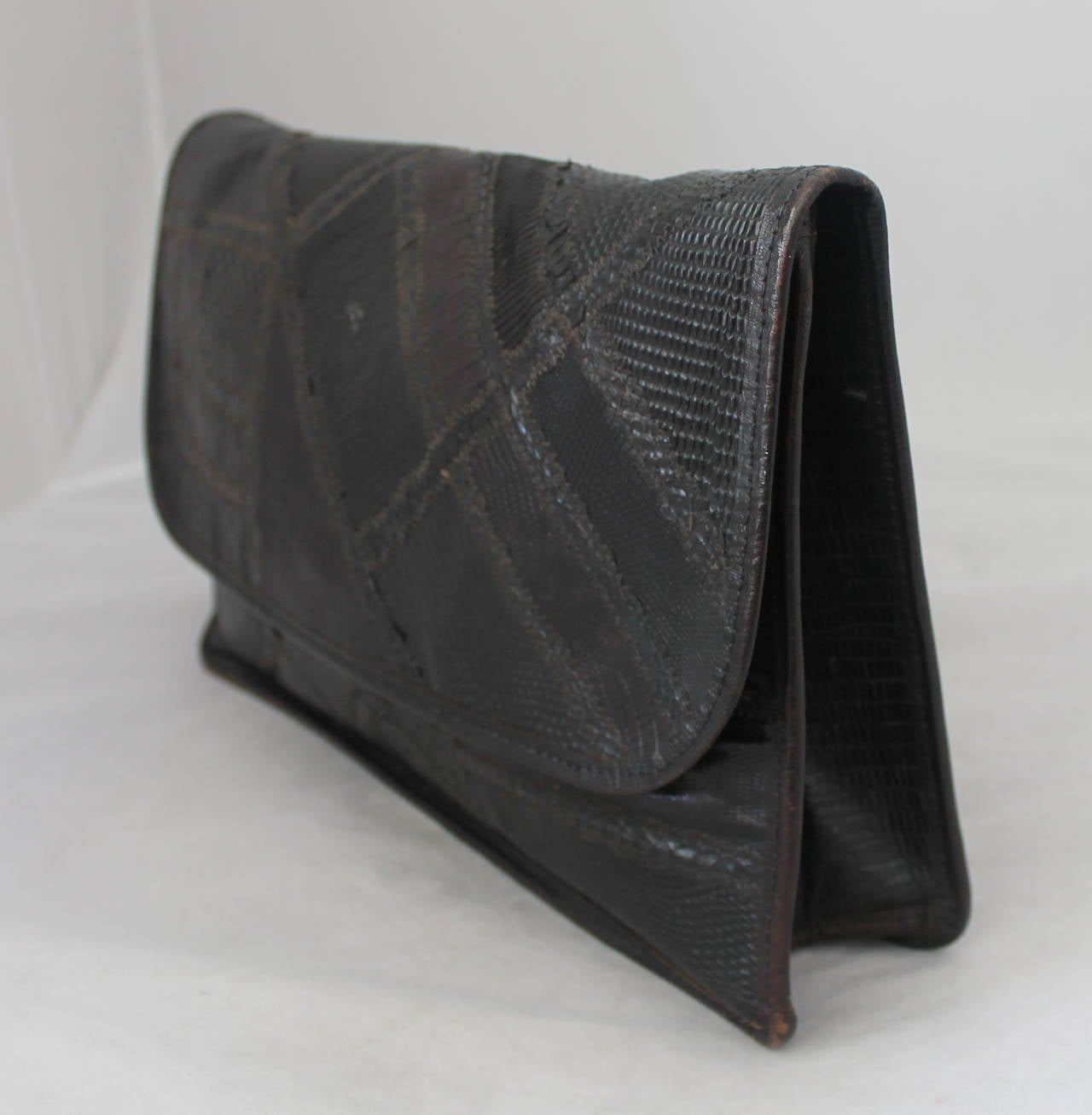 Carlos Falchi 1980's Vintage Dark Brown Lizard & Snake Patchwork Large Clutch. This bag is in fair vintage condition with wear consistent to its age. There is some wear on the inside leather and on the bottom of it (images 5,6,8). Also, there is