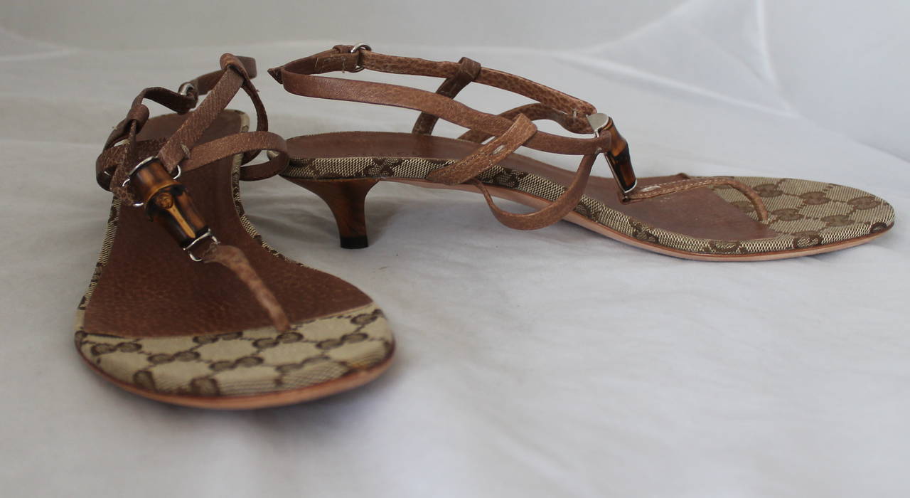 Gucci Brown Leather Thong Sandal with Bamboo Detail & Kitten Heel. These sandals are in fair condition with visible wear to the leather and bottom. It also has a Gucci monogram print on the bottom.