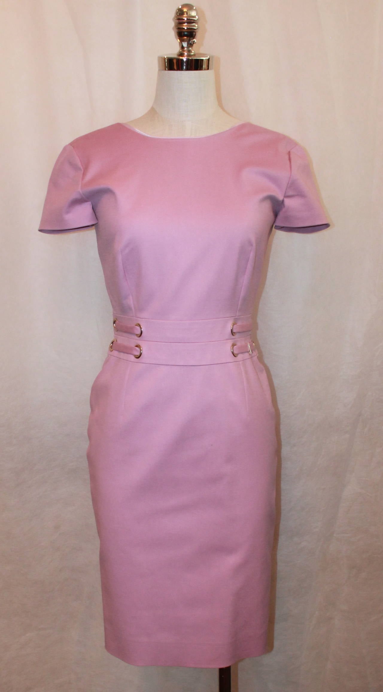 Versace Pink-Lavender Fitted Round-Neck Dress - 4. This dress is in excellent condition and is 98% cotton and 2% elastin. This sleeved dress has a grommet detail on the front waist as well as a 