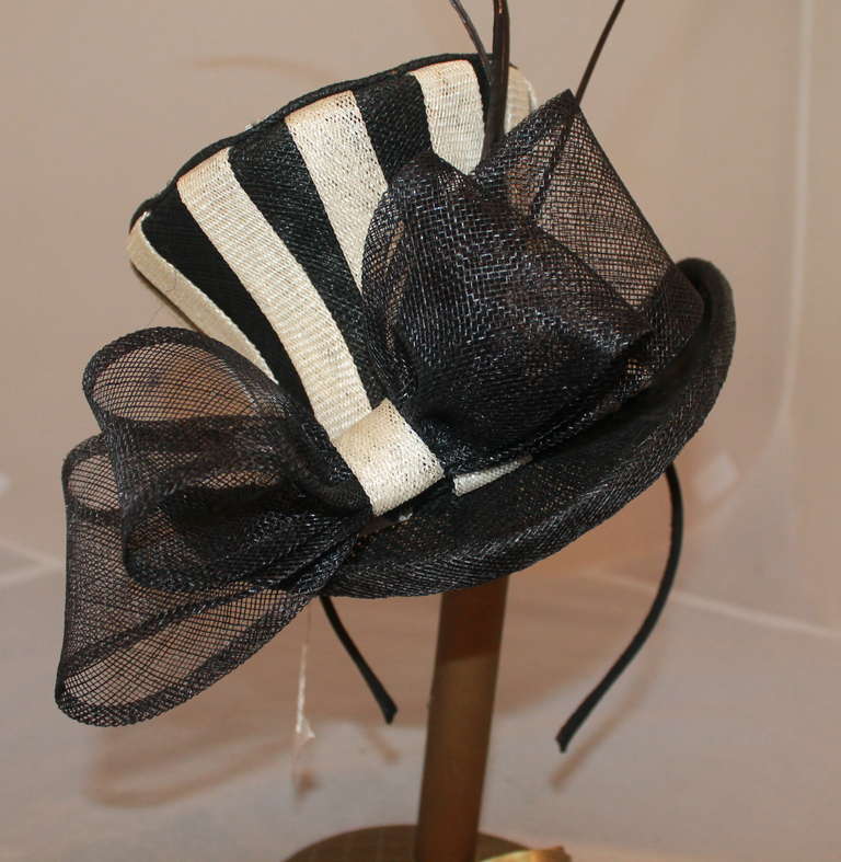 Herald & Heart Black & White Striped Top-Hat Style Fascinator Hat with star-shaped crystals and tortured quill accents. This hat is brand new and a current piece.