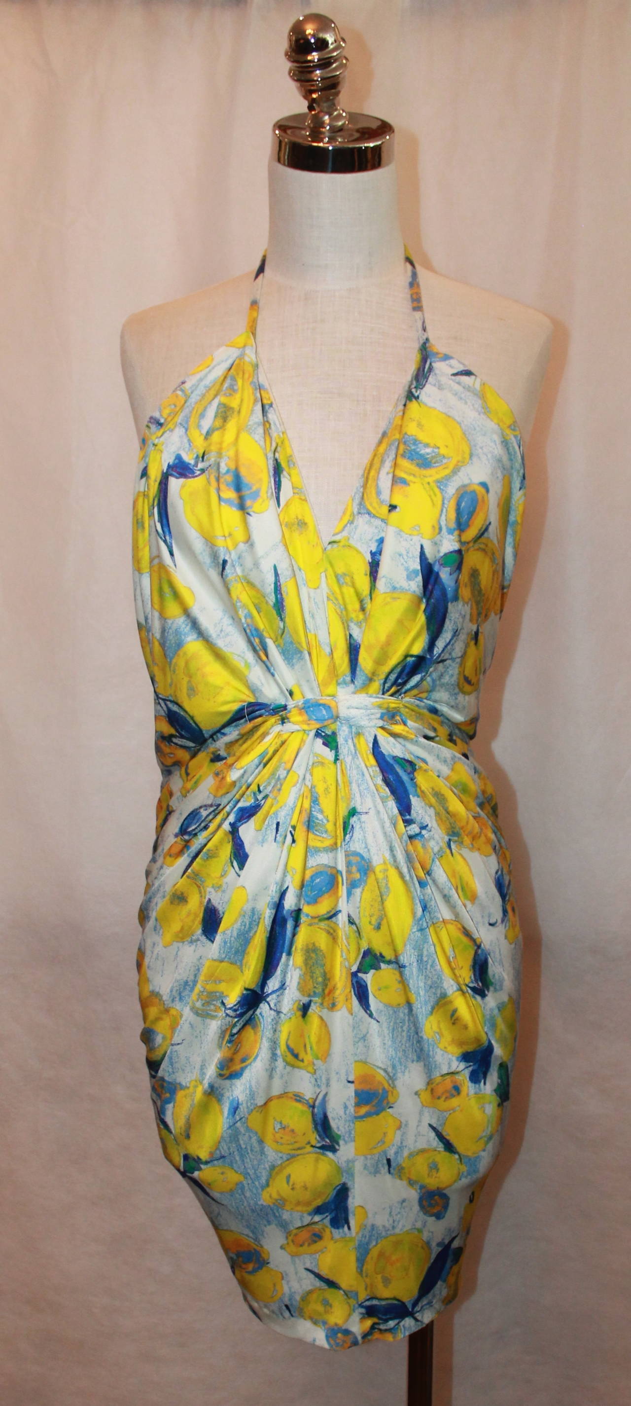 Blumarine Multi Color Blue, White, and Yellow Print Halter Dress with Gathering in the Center. This Small Sized Dress has a Tapered and Loose Fit and is in Excellent Condition.

Fabric:
Silk Jersey

Measurements:
Bust: up to 34 