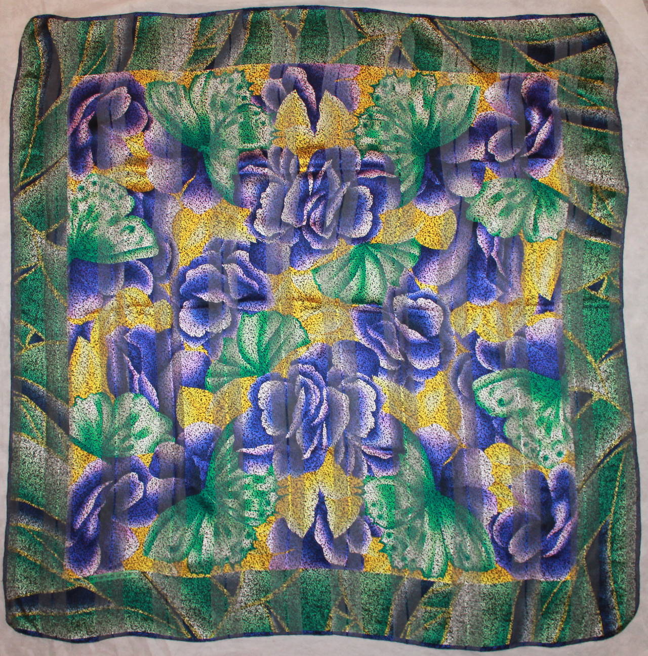 Emanuel Ungaro Green, Purple & Yellow Floral Silk Shawl. This shawl is in excellent condition and has purple flowers with green petals and a yellow background. 

Length- 53.75