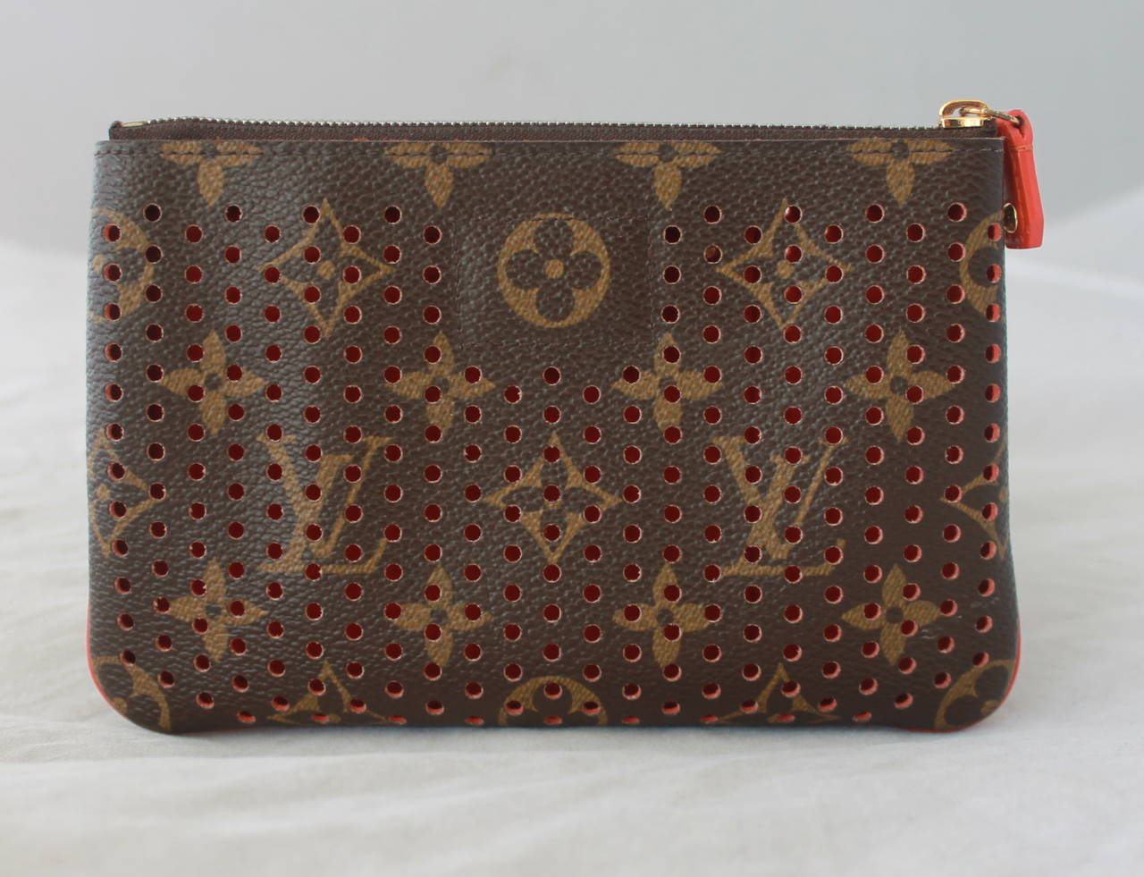 Louis Vuitton 2001 Perforated Brown & Red-Orange Monogram Case. This case is in very good condition with the only issues being very slight wear on the inside and one pen mark seen on image 6. 

Height- 4.45