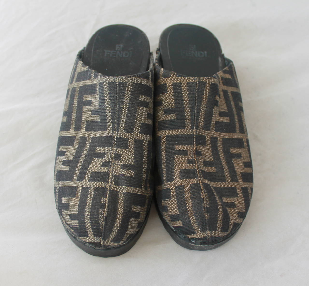 Fendi Brown Monogram Printed Fabric Clogs - 6. These shoes are in very good shape with minor wear on the bottom and minor marks on the large heel. The clog is hard and has a wooden look.