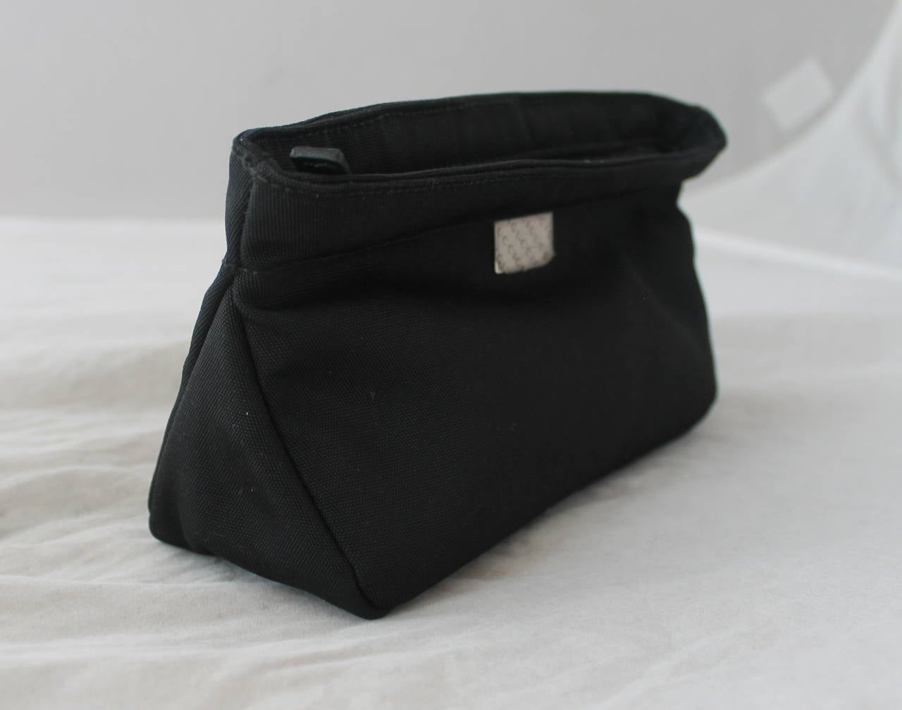 Gucci Black Nylon Solid Cosmetic Case. This case is in very good condition with the plastic still on the hardware. There is minor wear on the outside from sitting around. 

Height- 4.5