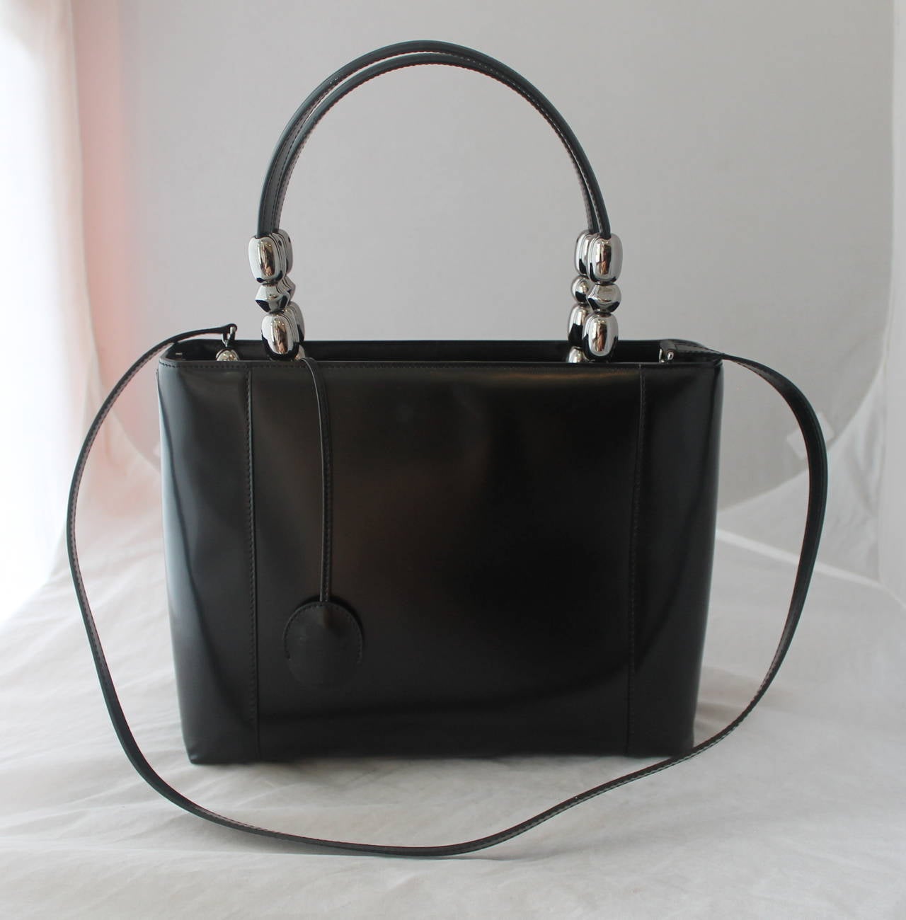 Christian Dior Black Leather Chrome Beaded Malice Tote. This handbag is in very good condition with the only issue being that it has one slight mark seen on image 2 in the upper portion of the bag. 

Measurements:
Height- 9