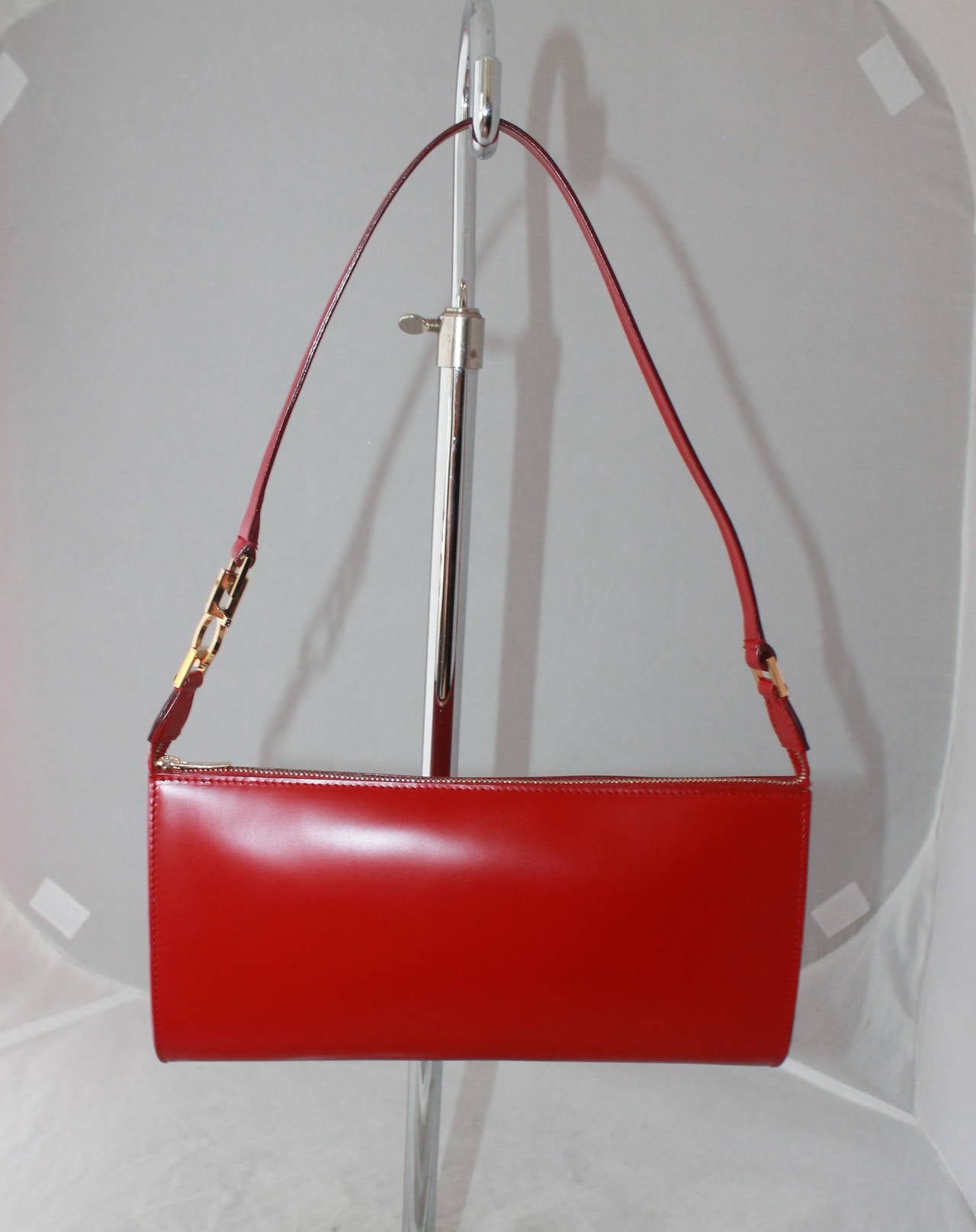 Salvatore Ferragamo Red Patent Pouchette GHW. This bag is in excellent condition and comes with a duster.

Height- 4.75