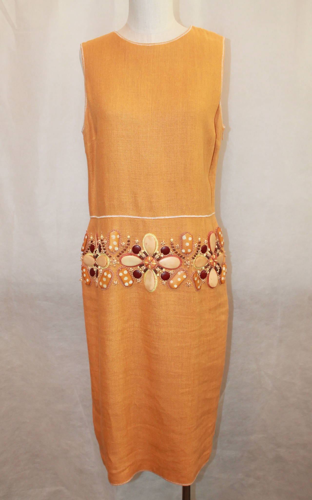 Oscar de la Renta Mustard Linen Heavy Floral Beaded Dress - 12. This dress is in excellent condition with only 1 area of beads coming loose in the back (minor). The beads lay around the hips and are tropical floral beads. It also has a pleat in the