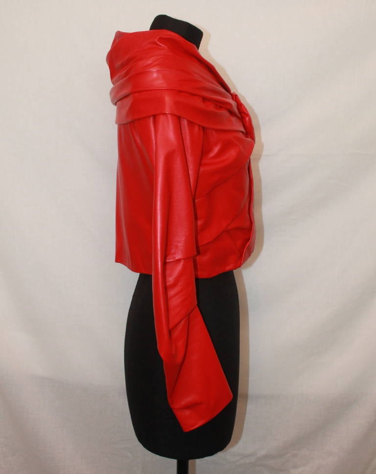 Emanuel Ungaro Red Leather Jacket - S. This rouched collar jacket has a flower accent and unique blue lining. It is in impeccable condition.

Measurements:
Bust- 37