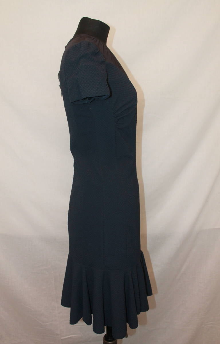 Nina Ricci Vintage Navy Dress - 38. This dress has a ruffled hem and an illusion bodice. It is in excellent condition.

Measurements:
Bust- 33