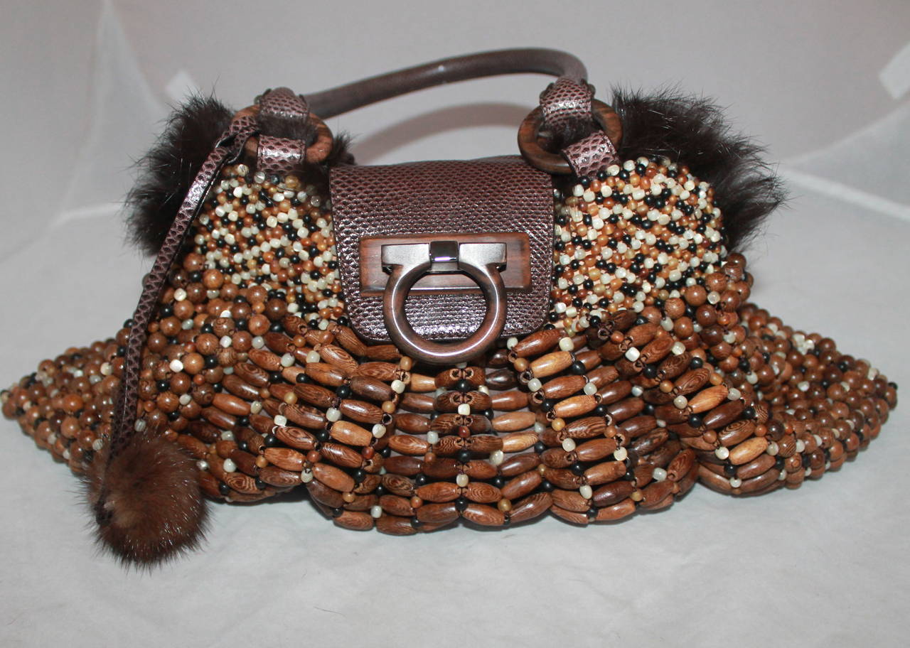 Salvatore Ferragamo Brown Beaded Handbag with Lizard Trim & Fur Lining. This bag is in excellent condition and has faux fur. The beads are a combination of wooden and pearlized beads.

Measurements:
Height- 8.25
