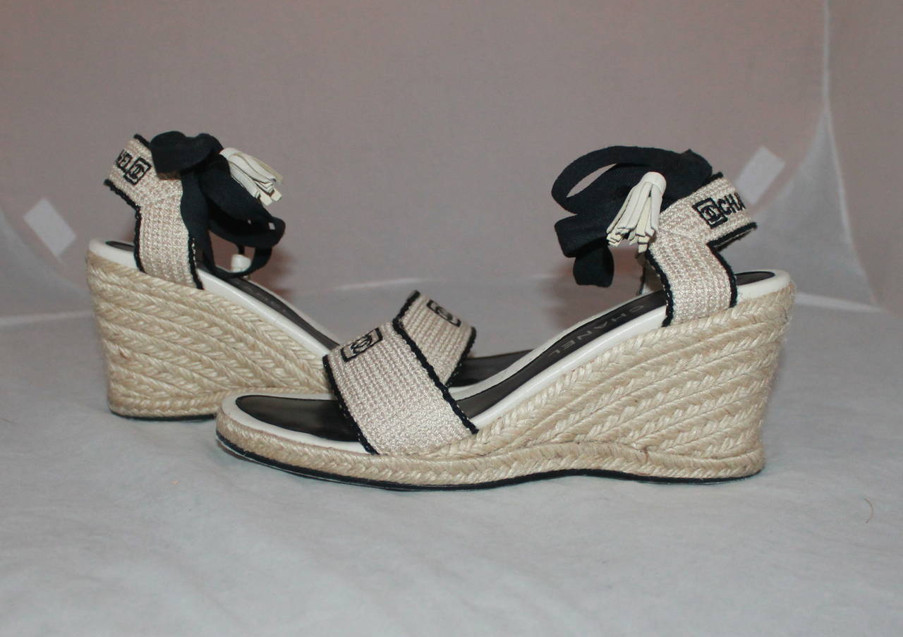 Chanel Beige & Black Woven Espadrille Wedges - 40. These shoes are in good condition with a few areas that have marks (images 3 & 4). The bottom has some wear.