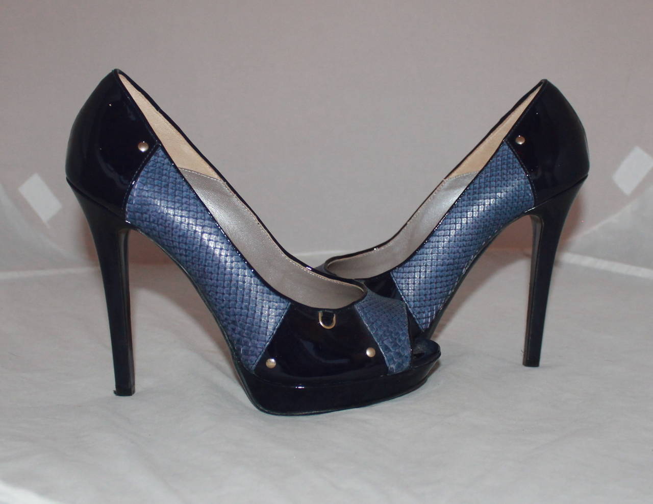 Versace Indigo Snake & Patent Peep-toe Pumps - 40. These shoes are in excellent condition with barely any wear on the bottom. One bottom heel has a chip but it does not affect the patent and can be replaced (image 5).