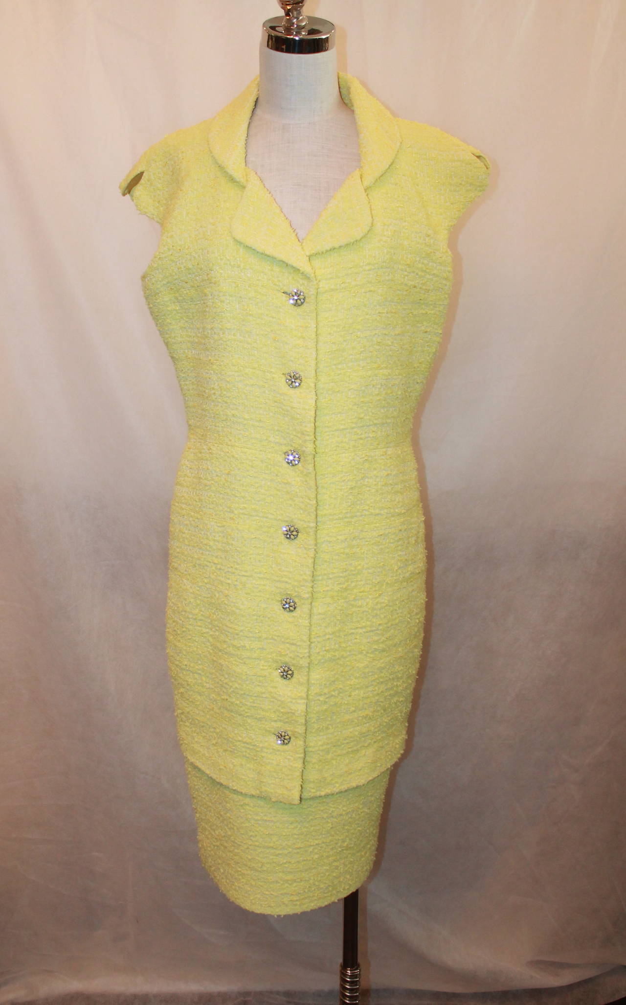 Chanel Yellow Tweed Sleeveless Coat Dress with Snake Belt - 44. This dress is in excellent condition and has buttons with rhinestones & yellow stones. There are 7 in the front and another 3 in the back towards the bottom. The belt is a yellow