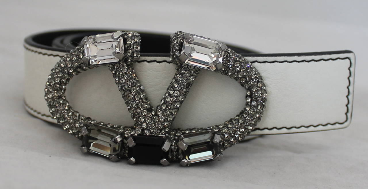Valentino White Leather Belt with Grey, Black & Clear Rhinestone Logo Buckle. This belt is in excellent condition and has a removable buckle. It is a size 85/34 and has only slight white marks on the inside which cannot be seen when worn.

Belt