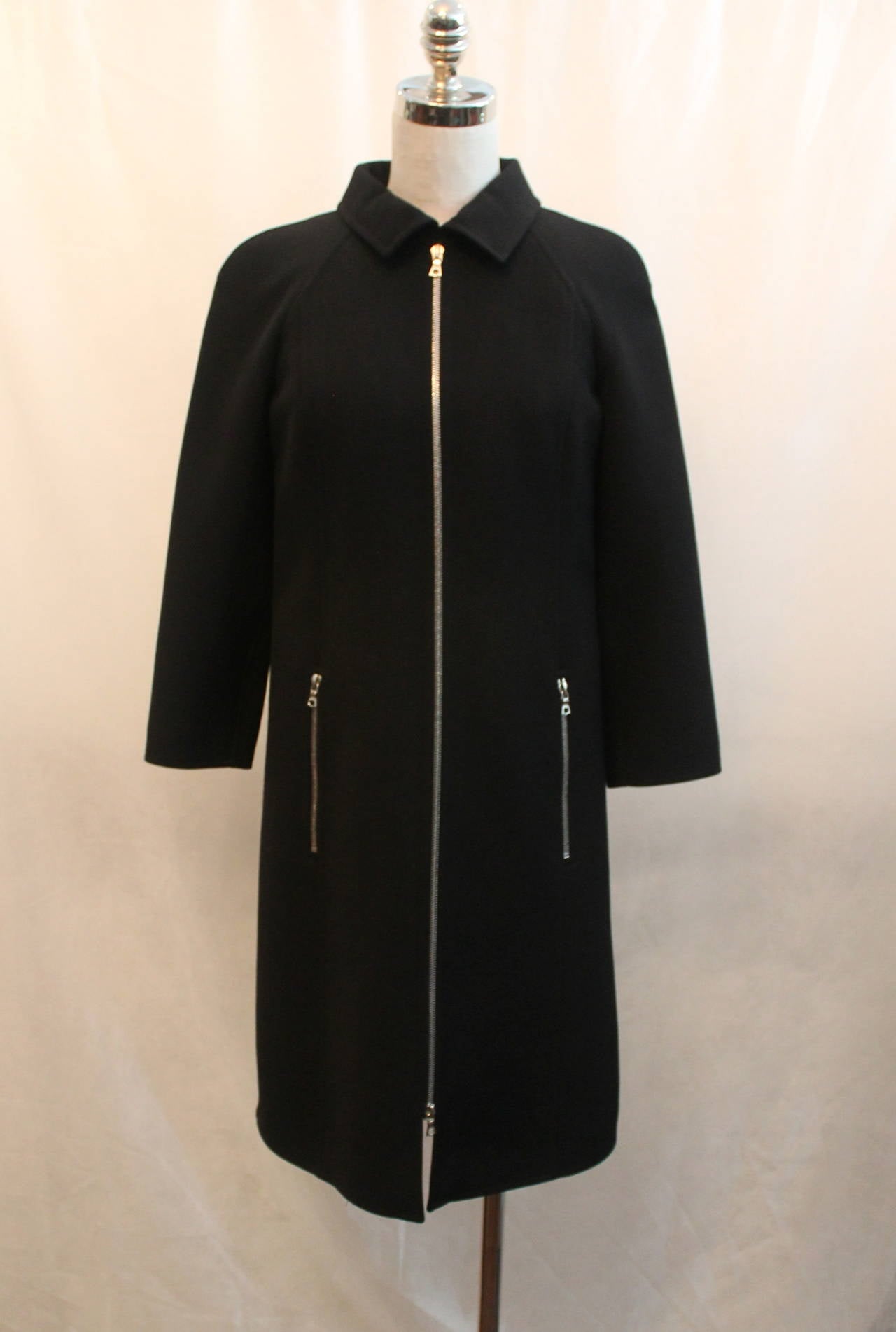 Courreges Black Wool Coat with Front Zip - 38. This coat is in excellent condition and has a silver zipper down the middle & two pockets with silver zippers in the front. 

Measurements:
Bust- 36