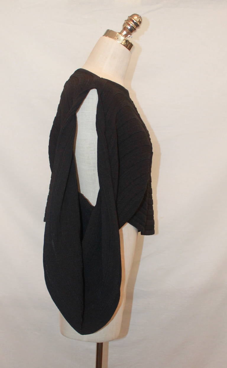 Chanel Black Asymmetrical Ribbed Poncho - 40. This top is an acrylic blend and is in excellent condition. Circa 2009.

Measurements:
Shoulder to Shoulder- 15