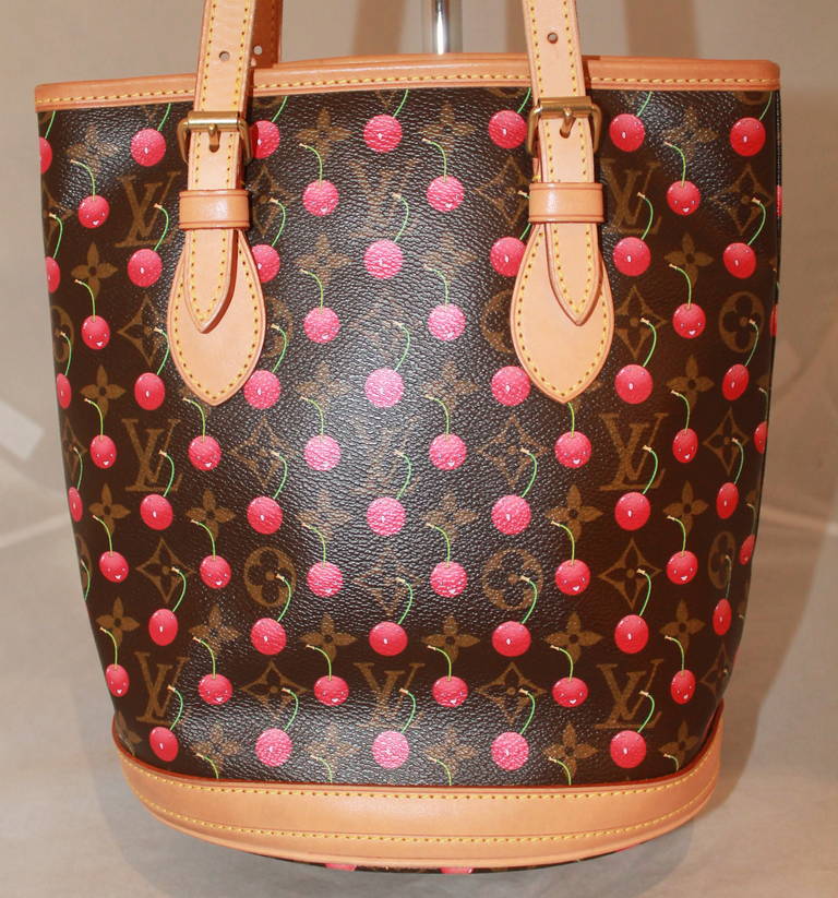 Louis Vuitton Cherry Handbag & Coin Purse. This bag is in impeccable condition with a unique red lining.

Measurements:
Height- 10.5