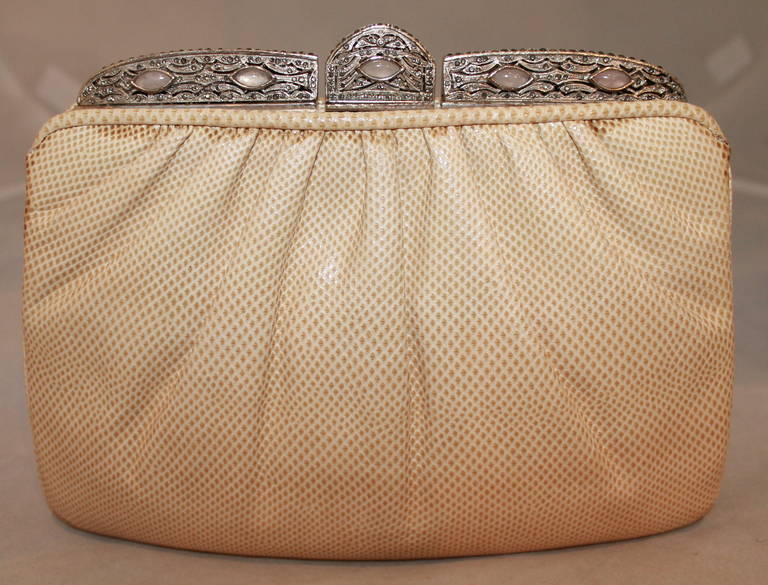 Judith Leiber Creme Karung Snake Clutch SHW. This bag is in excellent condition with a duster included. The option silver strap has a broken piece but can be easily fixed. The silver has small pale pink stones and rhinestones.