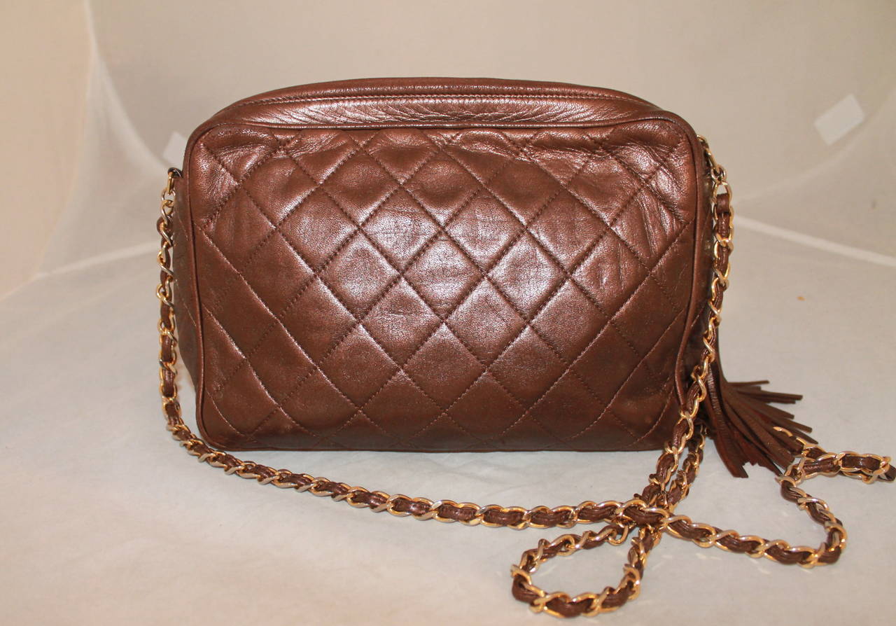 Chanel Vintage Bronze Lambskin Quilted Camera Case - circa 1991. This handbag is in good vintage condition with moderate signs of wear. 

Measurements:
Length- 7.5
