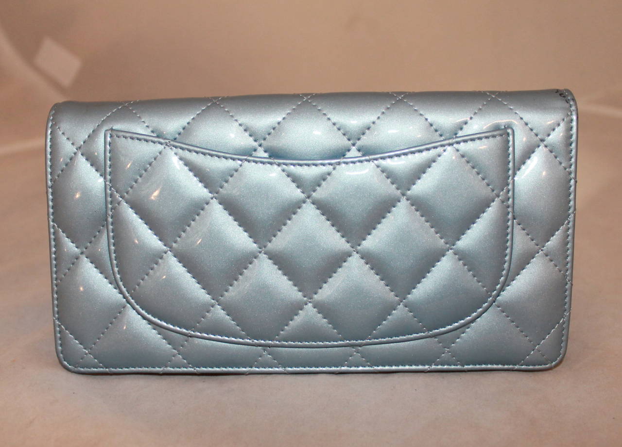 Chanel Patent Quilted Baby Blue Wallet. This wallet is in fair condition with small noticeable blue stains on the front of the wallet.

Measurements:
Length- 4