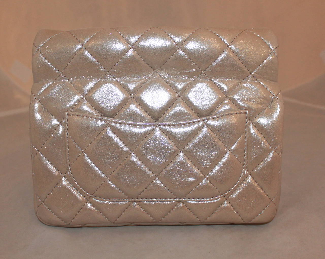 Chanel Iridescent Nude Reissue Style Roll Clutch - circa 2013. This clutch is in impeccable condition with no markings. It comes with a duster and card. 

Measurements:
Length- 6.5