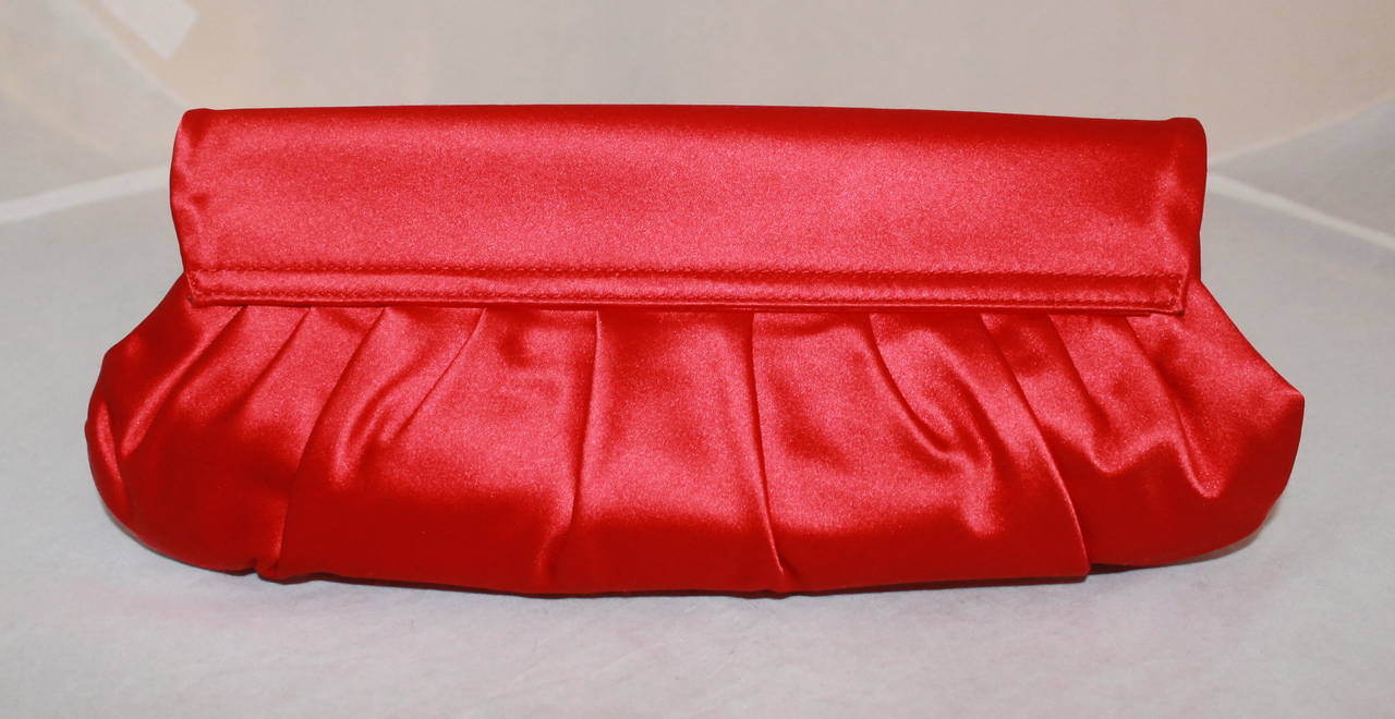 Ralph Lauren Collection Red Satin Clutch - Retail $2100. This bag is in impeccable condition and was only worn once. It comes with a duster and card.

Measurements:
Length- 5.5