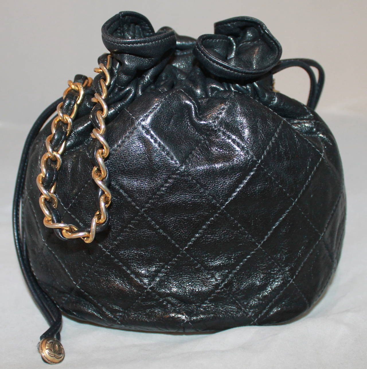 Chanel Black Lambskin Quilted Mini Drawstring Handbag - circa 1997. This handbag is in impeccable condition with no markings. Comes with duster. 6