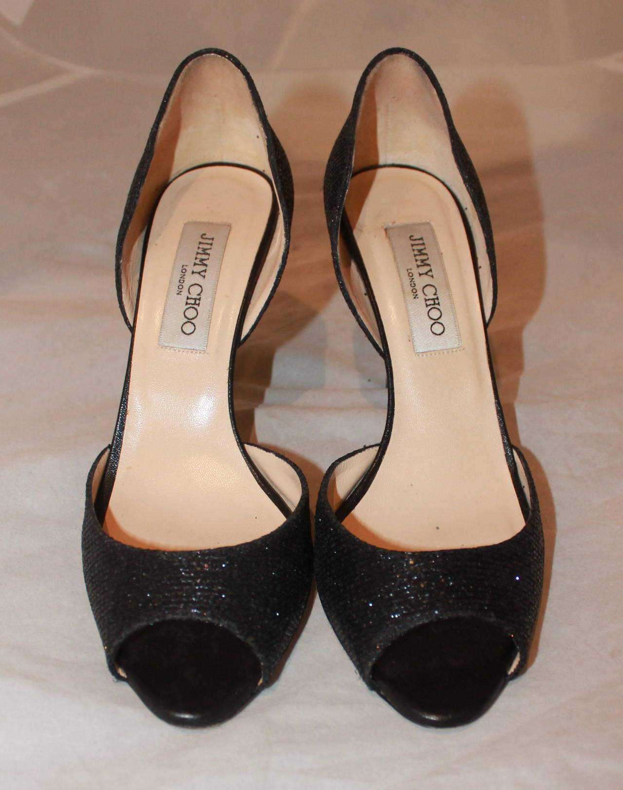 Jimmy Choo Black Sparkle Heels - 37.5. These shoes are in excellent condition with minor wear on the bottom.