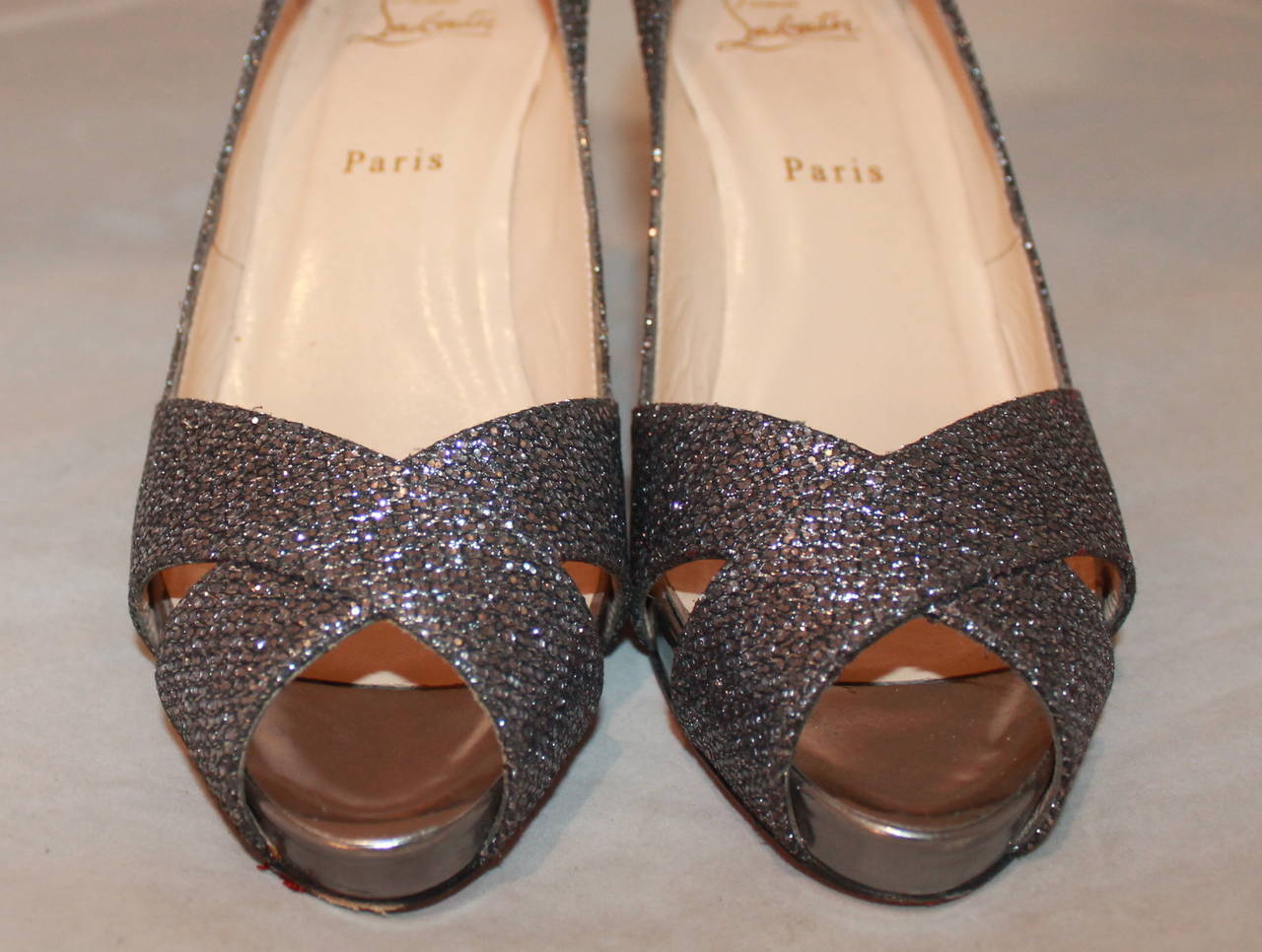 Christian Louboutin Gunmetal Sparkly Heels - 38.5. These shoes are in excellent condition with moderate wear on the bottom.