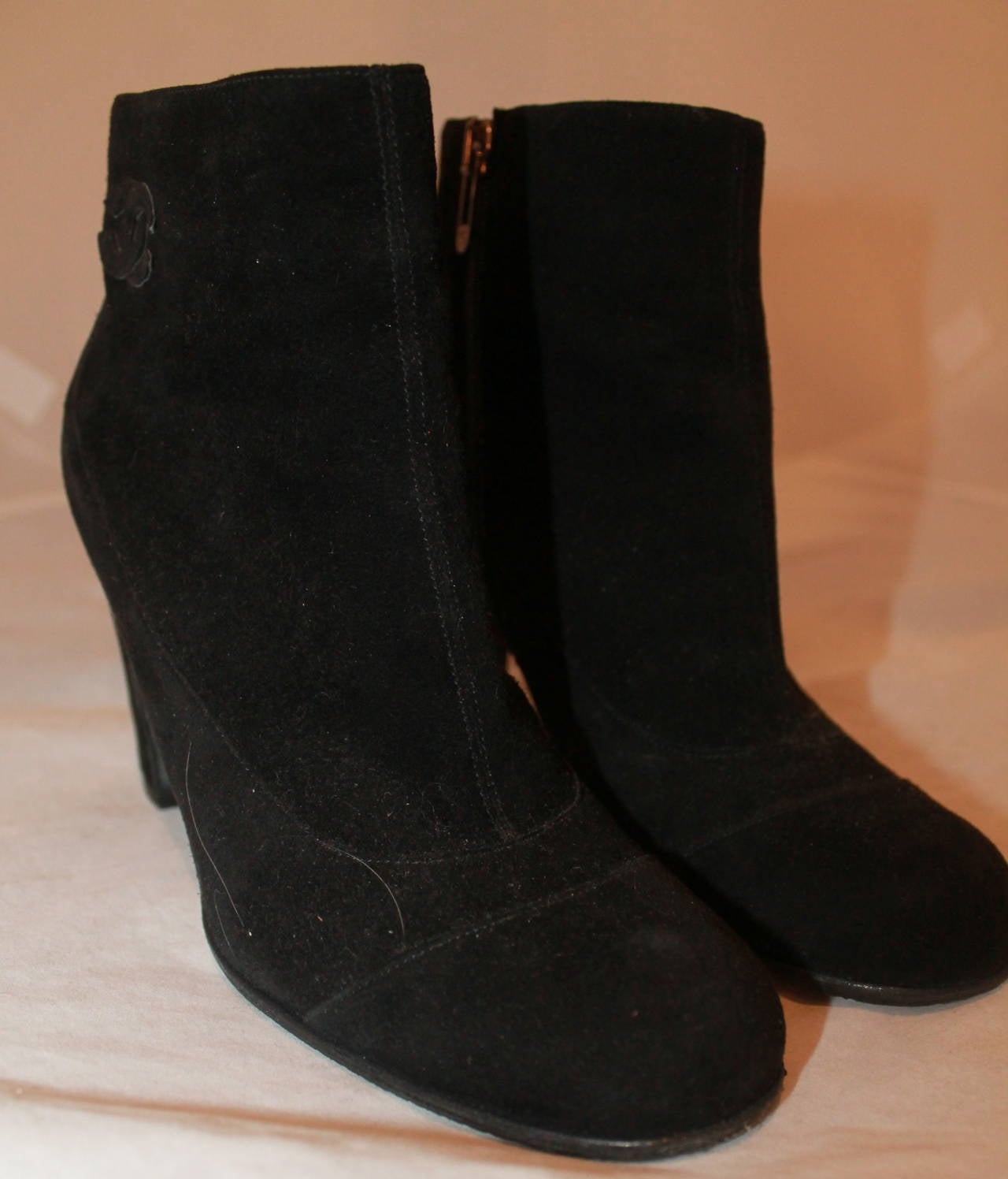 Chanel Black Suede Booties - 37. These booties are in excellent condition with visible wear on the bottom.