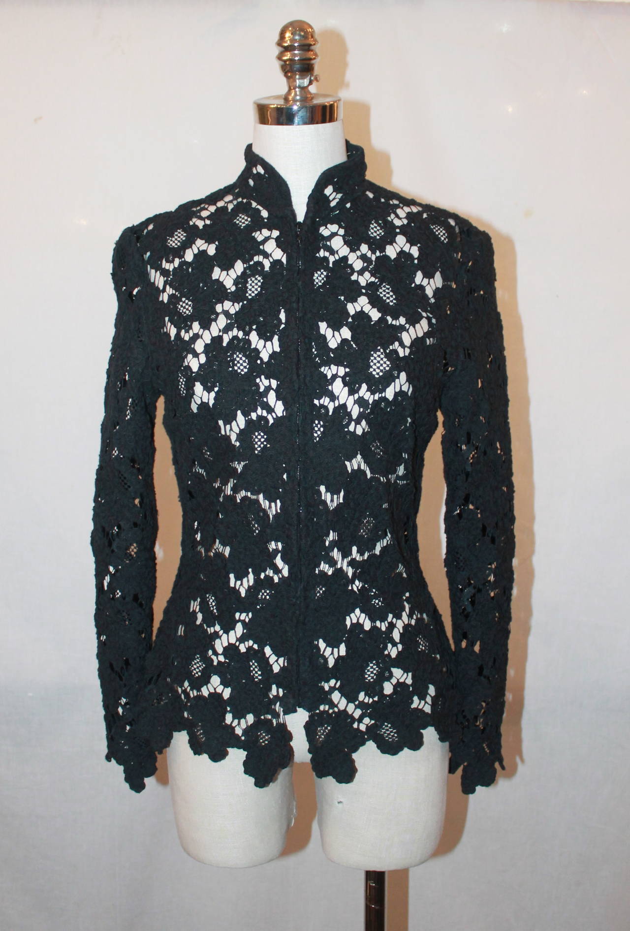 Chanel Black Lace Jacket with White Camelia Bow Tie - 42. This jacket is in excellent condition. The jacket can be worn as a blouse and it zips up. 

Measurements:
Bust- 34