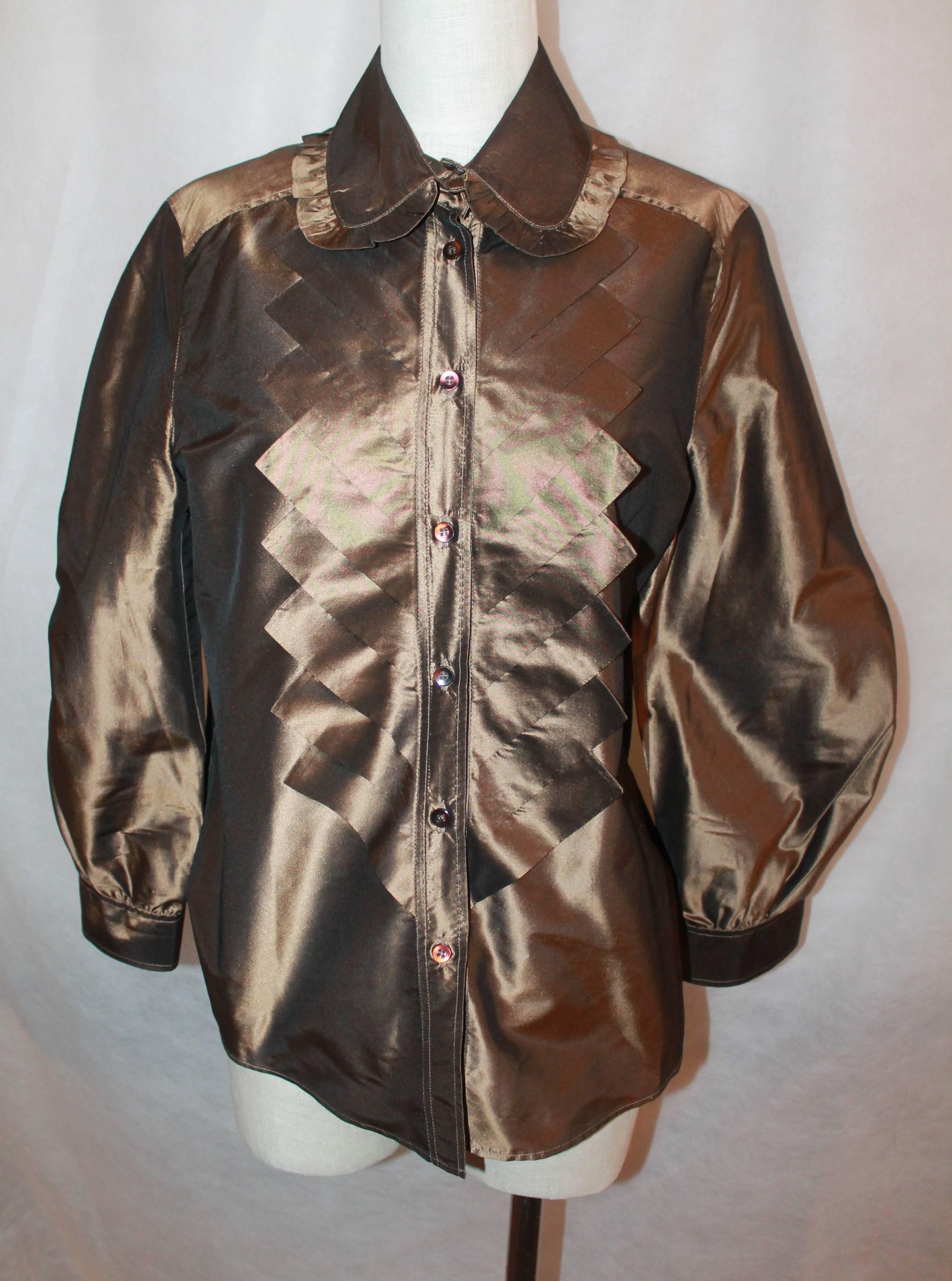 Oscar de la Renta Bronze Blouse - 12

This Oscar blouse is made of silk taffeta and is in excellent condition. It is layered in the front with a chevron fabric design. There is also a ruffle trim on the collar and has large sleeves.