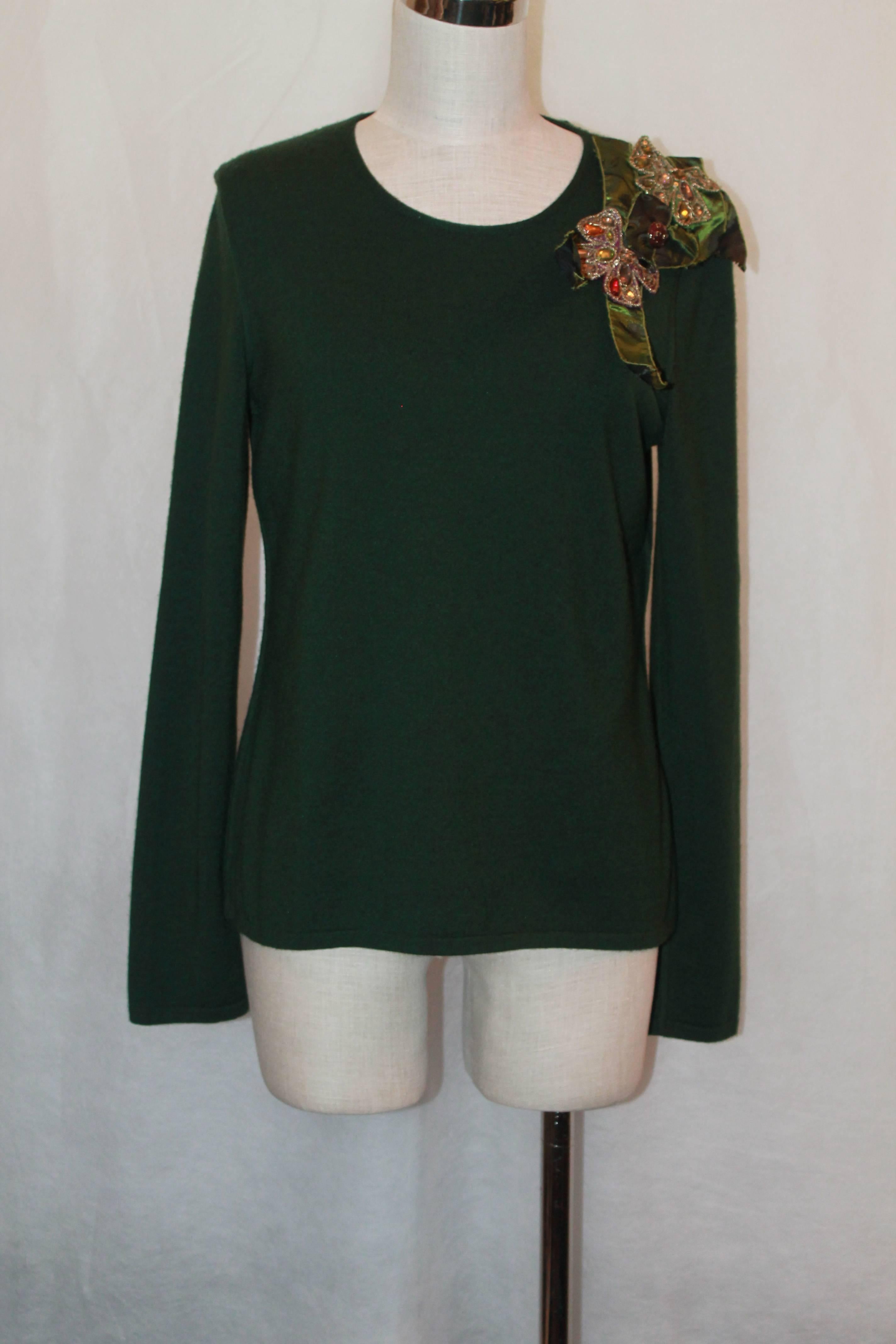 Oscar de la Renta Emerald Cashmere/Silk Blend Round Neck Sweater - Large.  This sweater is long-sleeved and has a jeweled and stitched cluster on the left shoulder.  It has an enamel gold and emerald button on the back.  It is in excellent