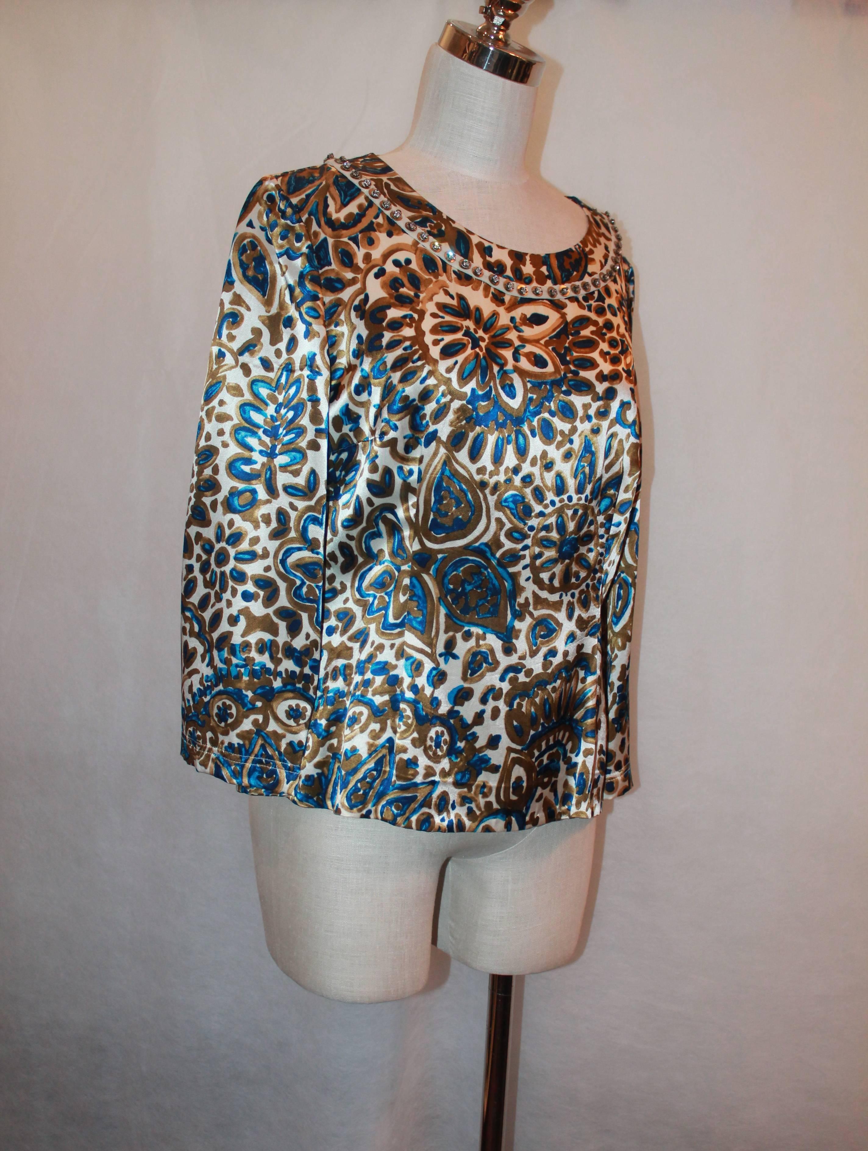Chloe Ivory, Blue, & Gold Paisley Printed Silk Blouse w/ Rhinestone Trim - 42.  This blouse is in excellent condition with a rhinestone trim along the neckline.  This silk blouse features a beautiful ivory, blue, and gold paisley